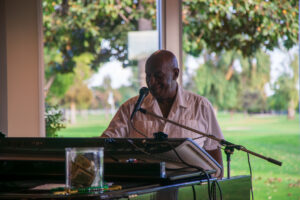 Man singing while playing a piano